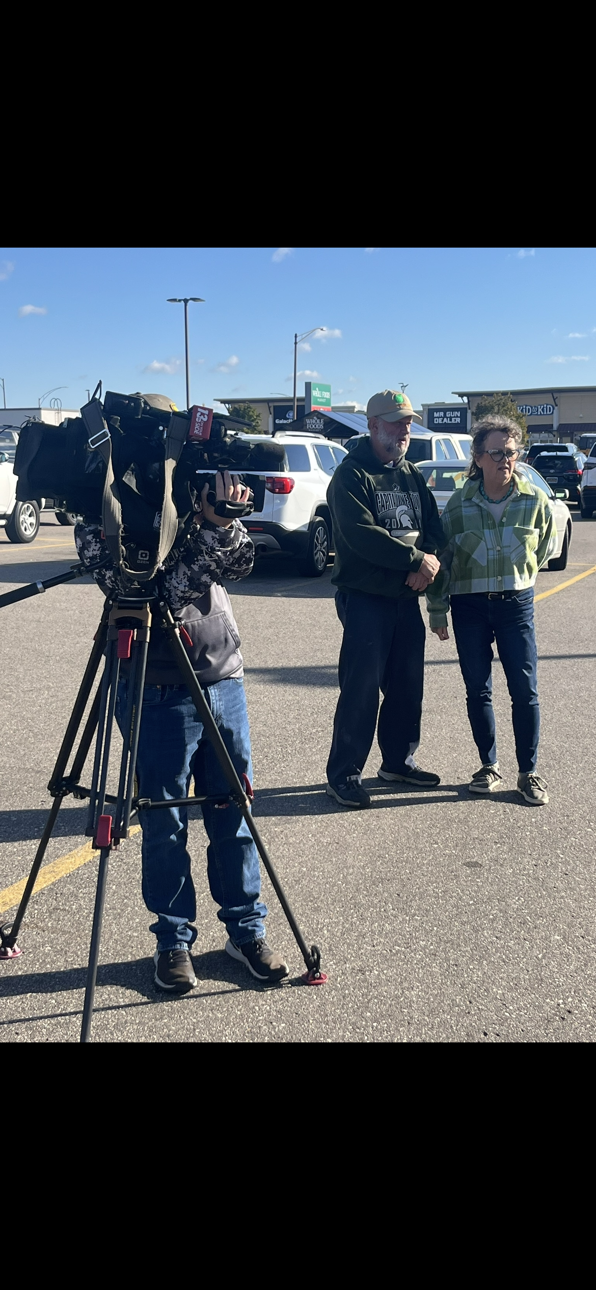 WZZM13 film crew interviewing Green Apple Pantry staff at the USPS food drive